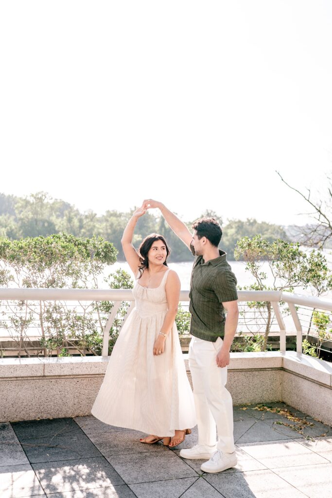 A couple sharing a dance on the terrace during their Kennedy Center engagement photos