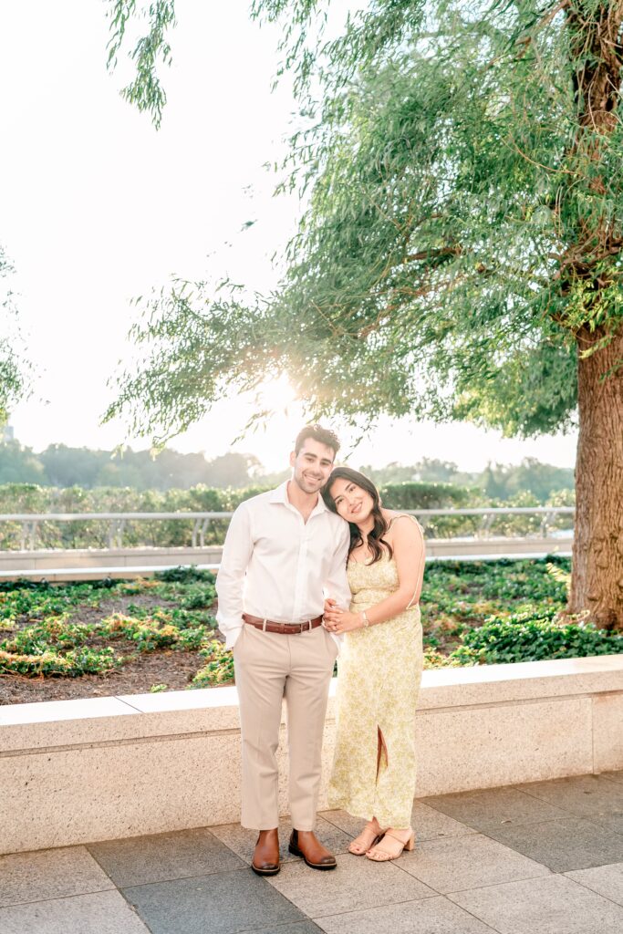 A couple posing for a cozy but classic portrait during golden hour at one of the best places to take engagement photos in DC