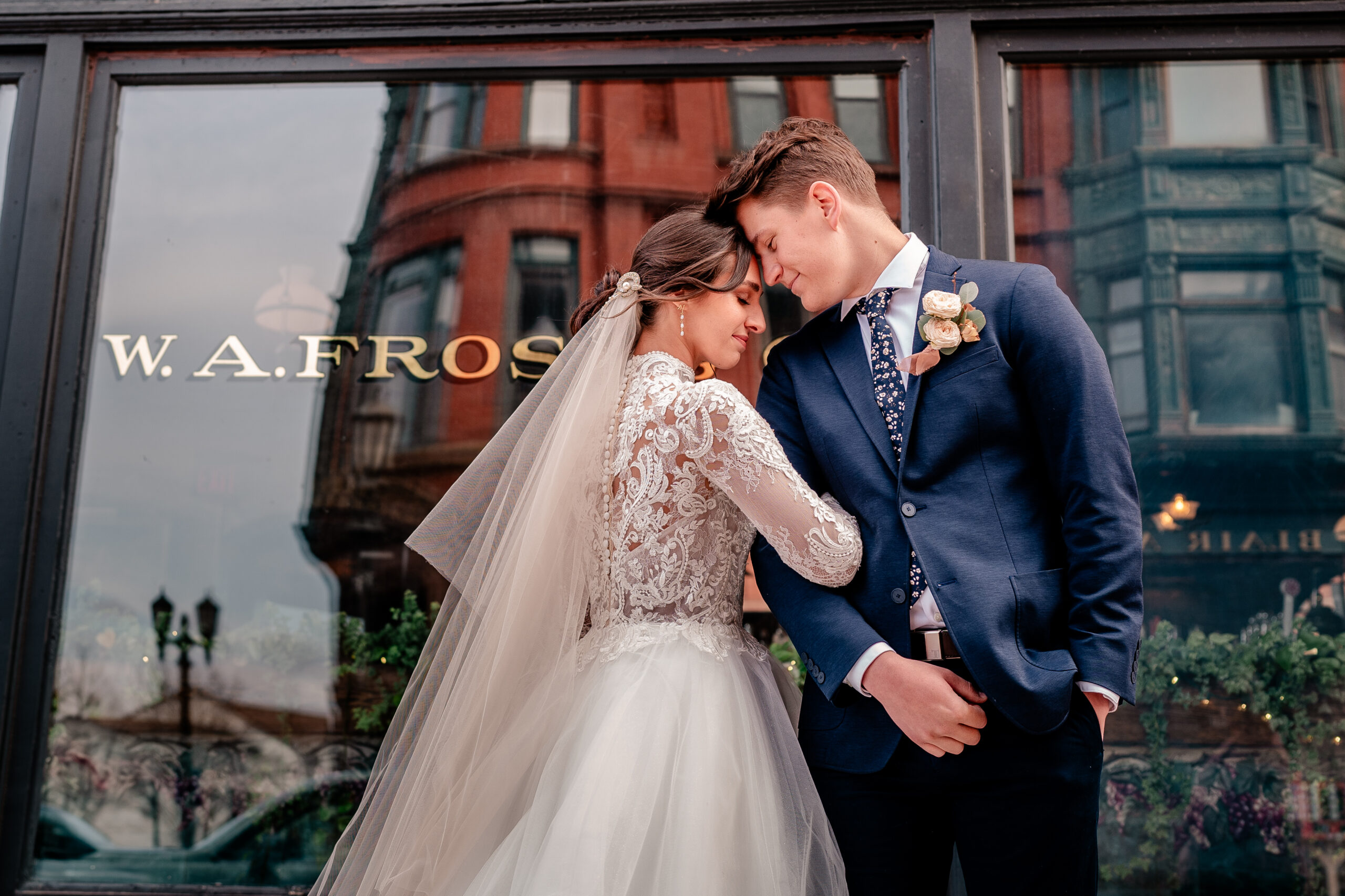 A bride and groom posed outside of a wedding venue for their Catholic wedding photographer Beauty of the Soul Studio