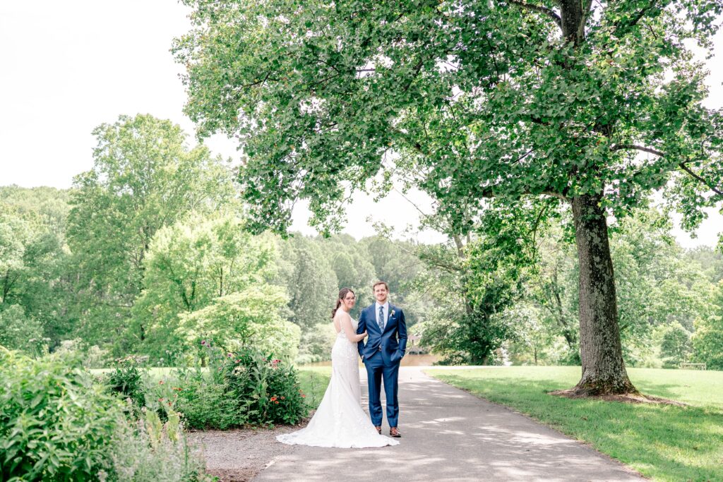 A bride and groom on a shady path with their Northern VA wedding photographer