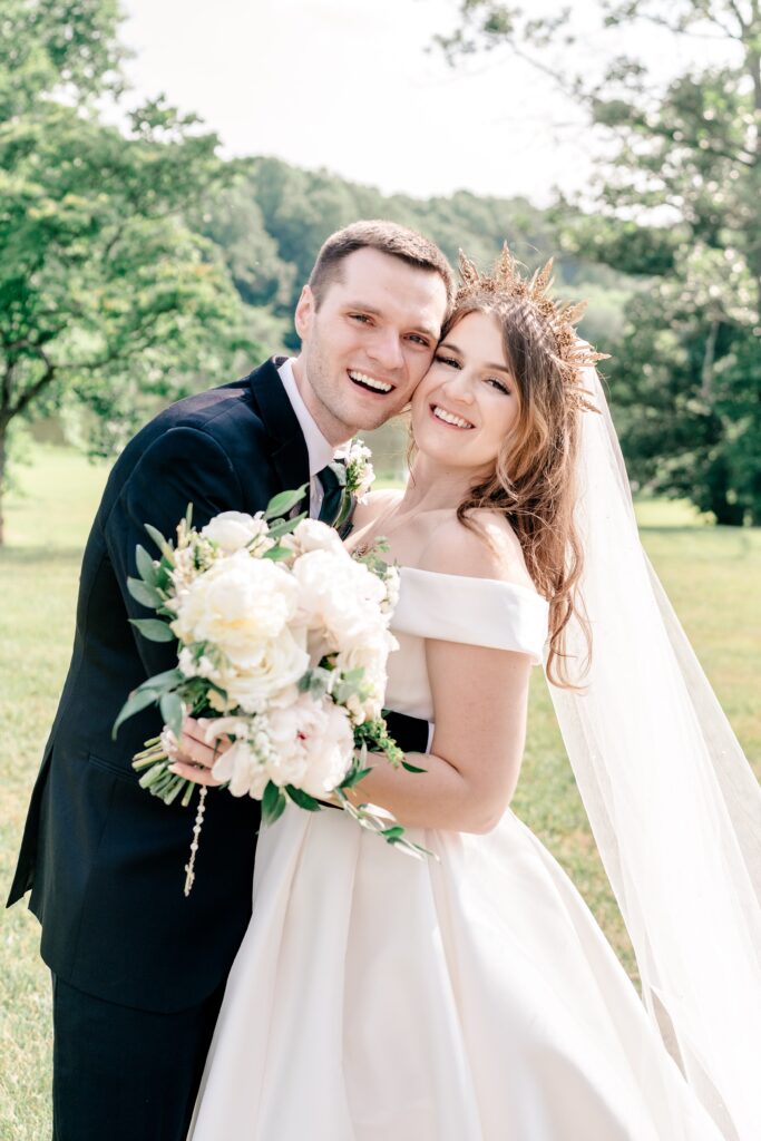 A bride and groom smile joyfully at the camera