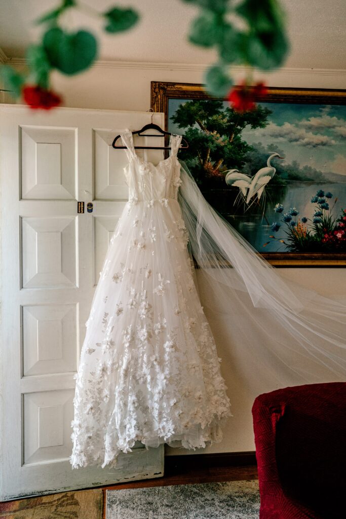 A wedding dress hanging on the front door for a Murray Hill wedding