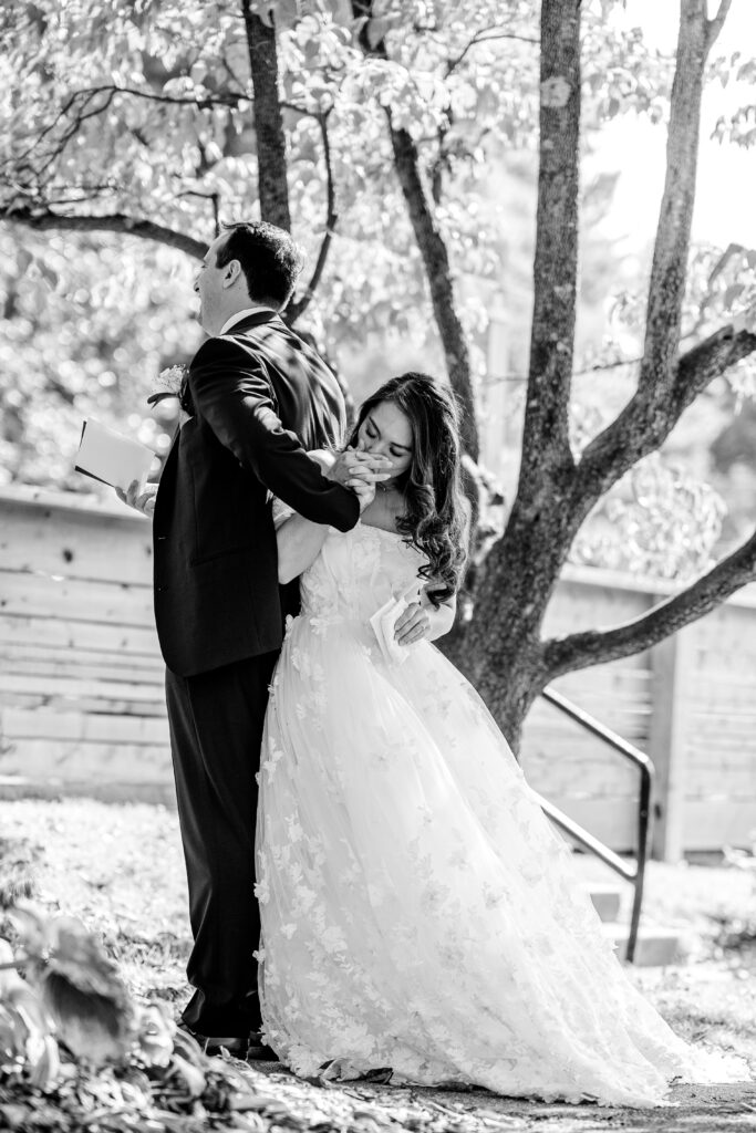 A bride kisses her groom's hand during their first touch