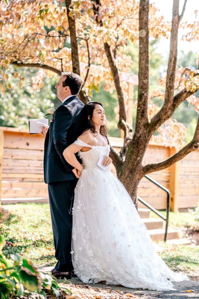 A bride and groom sharing a first touch before a Loudoun County wedding