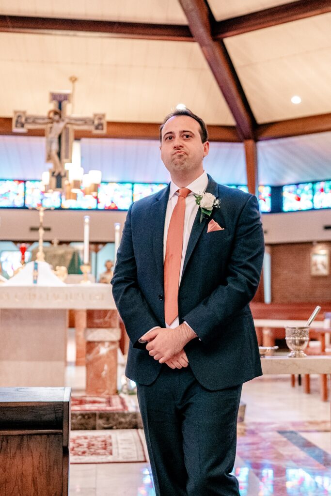 A groom holding back tears as he watches his bride walk down the aisle during their Murray Hill wedding