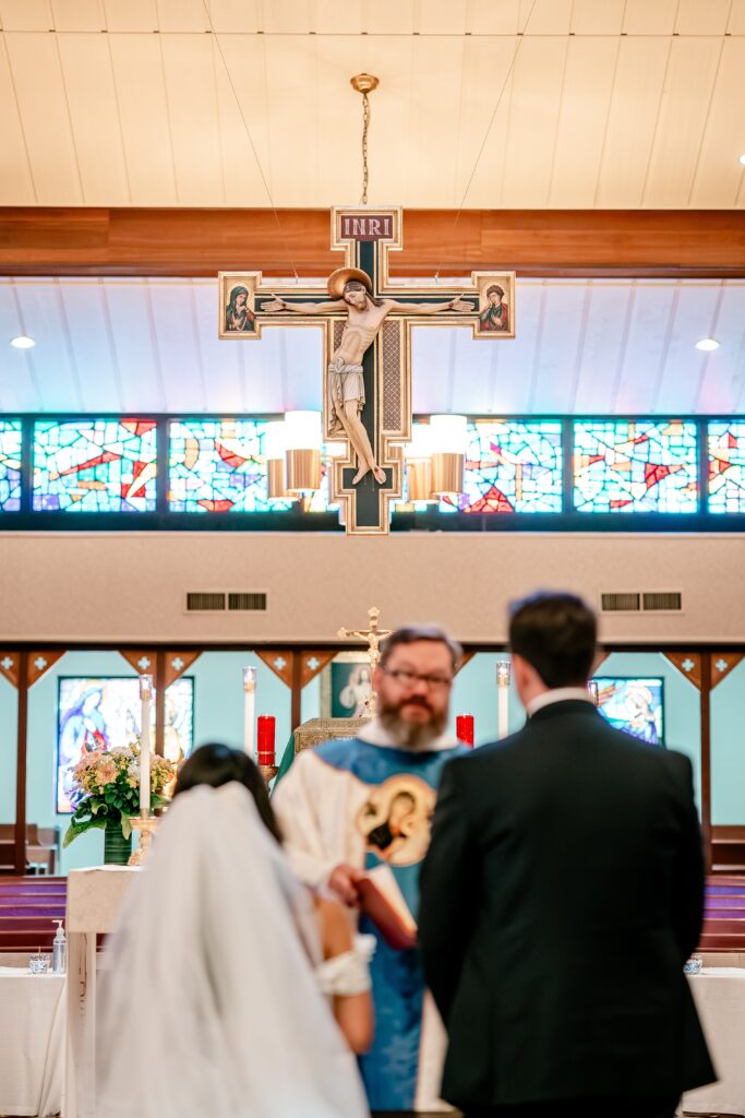 The crucifix hanging over the bride and groom at the church for a Loudoun County wedding
