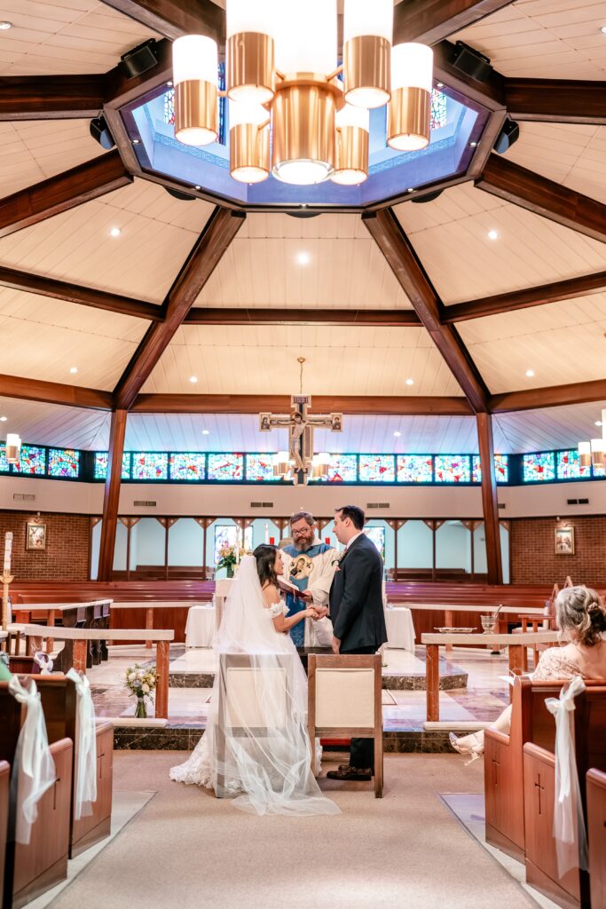 A bride and groom exchanging vows in a church