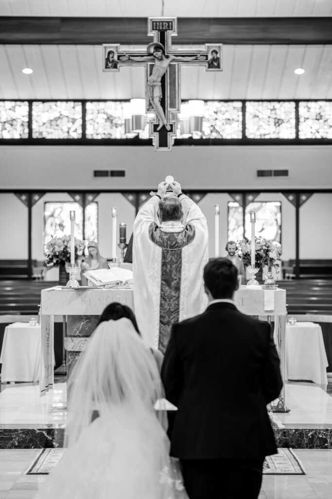 Consecration in front of the bride and groom during a St. John the Beloved wedding