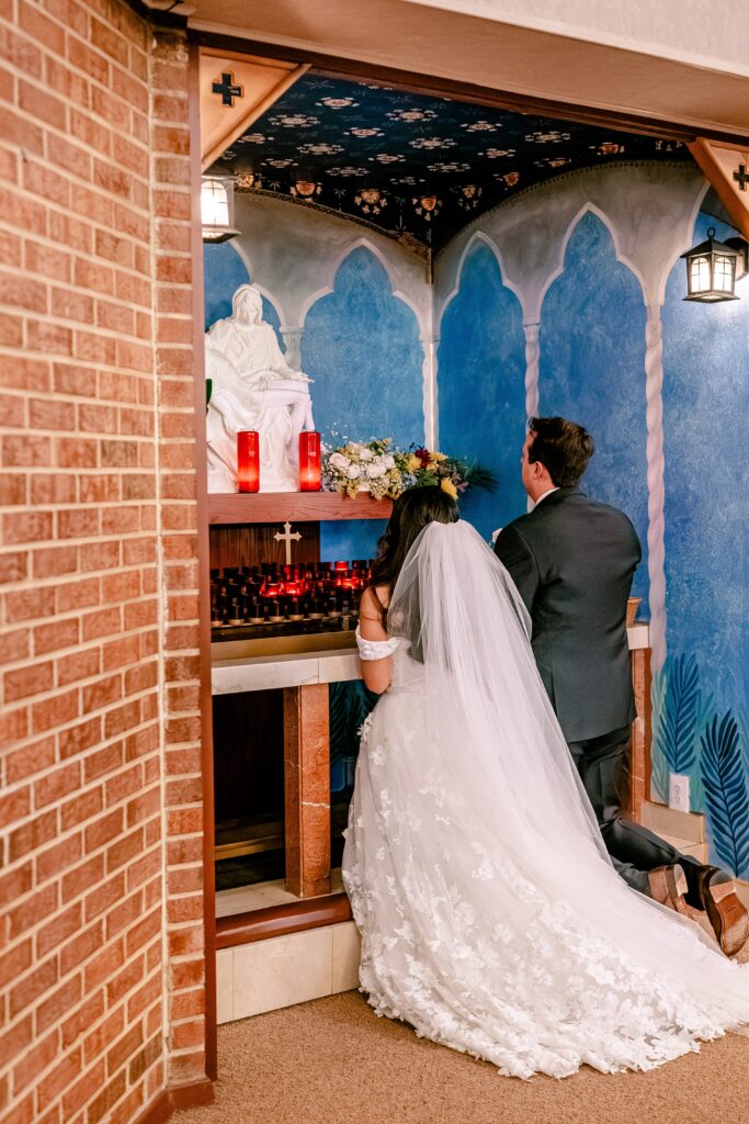 A bride and groom presenting flowers to Mary during their Loudoun County wedding
