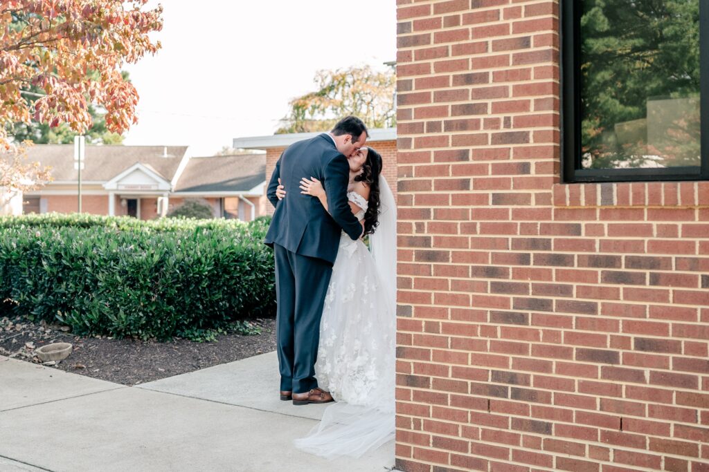 A bride and groom sharing a kiss after their wedding ceremony