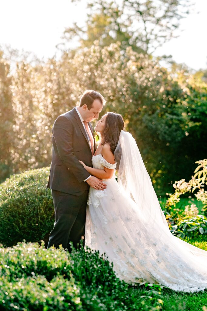 A bride and groom embrace during golden hour at their Murray Hill wedding