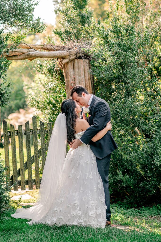 A bride and groom sharing a sweet moment in the garden at golden hour during their Loudoun County wedding