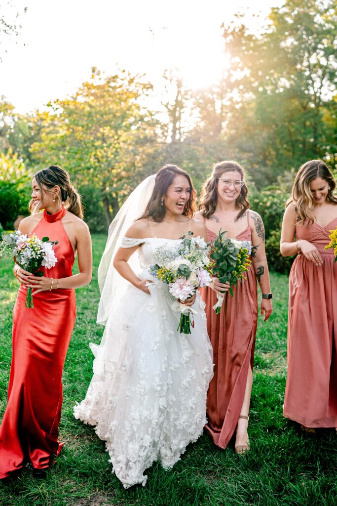 A bride and her bridesmaids laughing as they walk together
