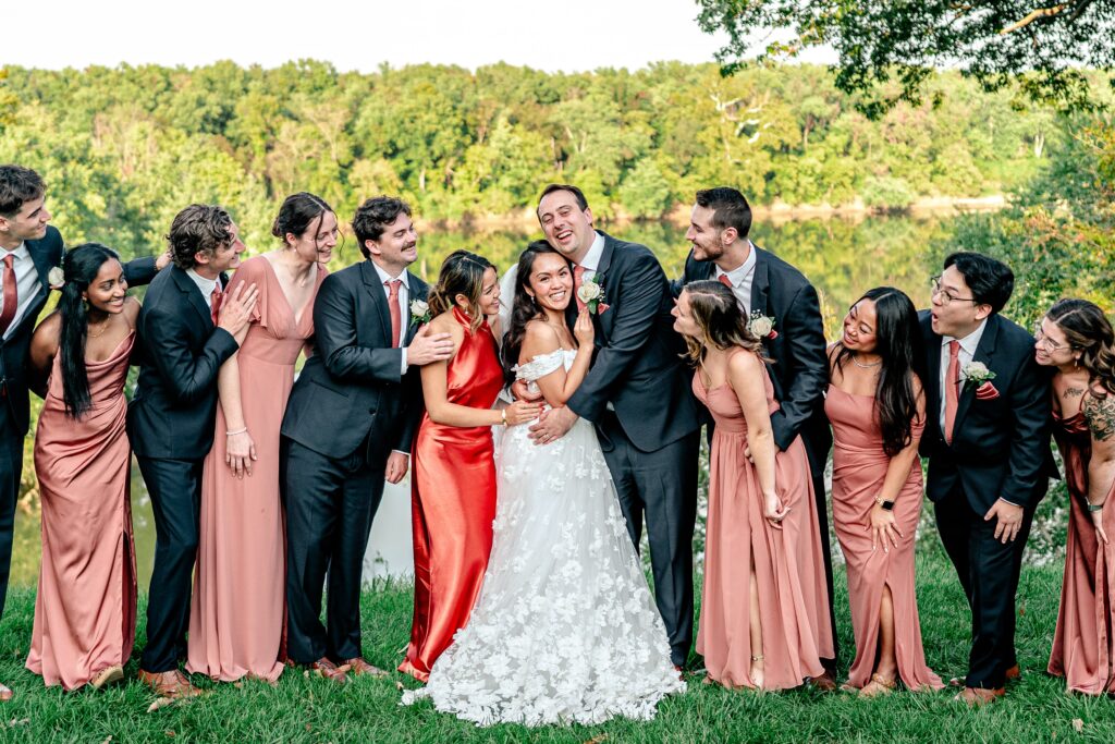 A wedding party gathers around the bride and groom during their Loudoun County wedding