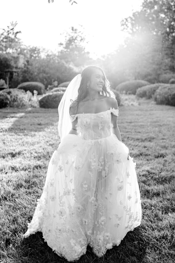 A bride walking through the garden during golden hour for her Loudoun County wedding