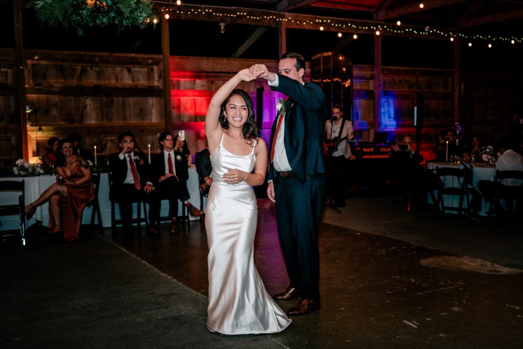 A bride and groom sharing their first dance after a St. John the Beloved wedding