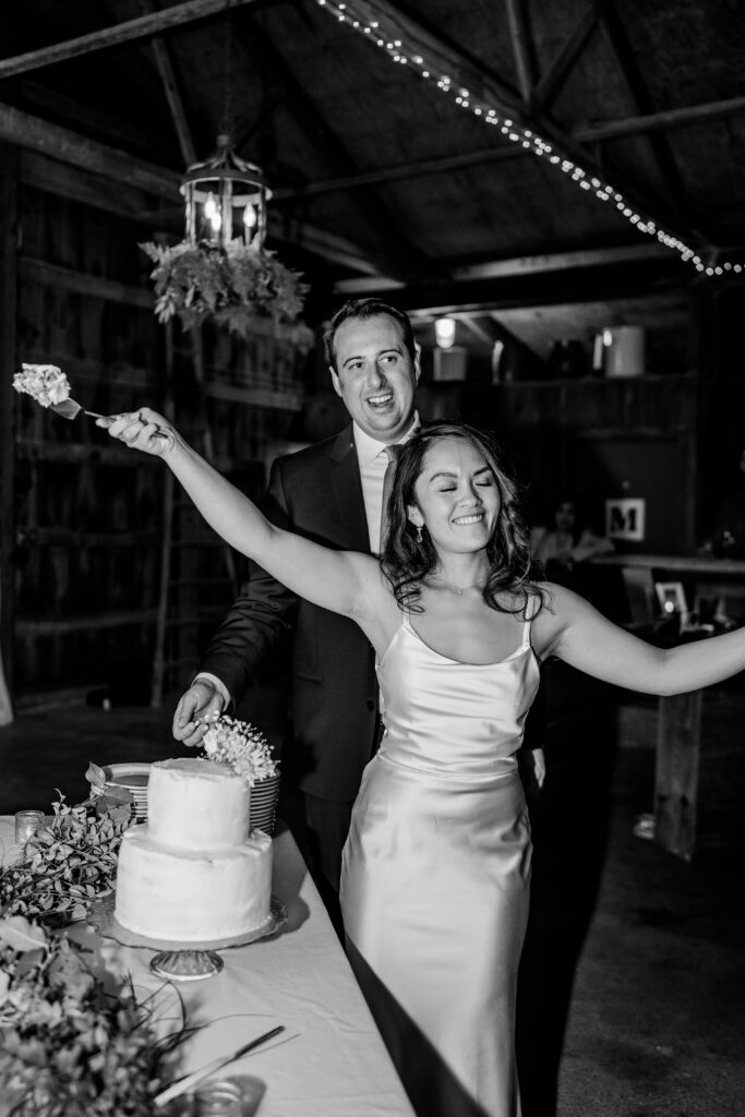 A bride and groom celebrating their cake cutting after a St. John the Beloved wedding