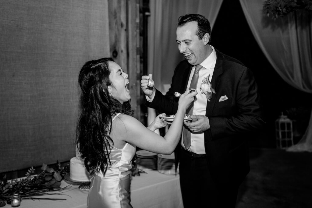 A bride and groom feeding each other cake during their Loudoun County wedding