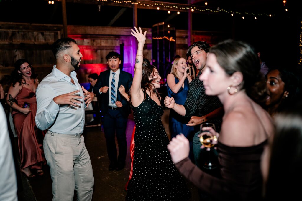 Wedding guests dancing on the dance floor after a St. John the Beloved wedding