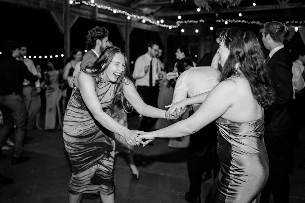Bridesmaids laughing together on the dance floor during a Murray Hill wedding reception