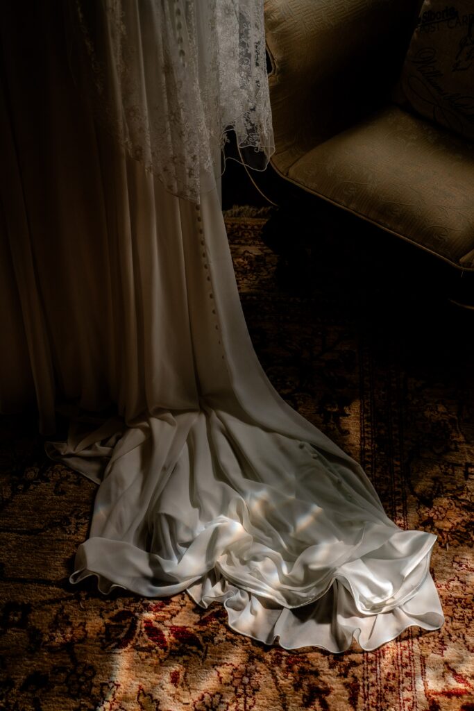 A bride's train resting in the light of a stained glass window during her Loudoun County wedding