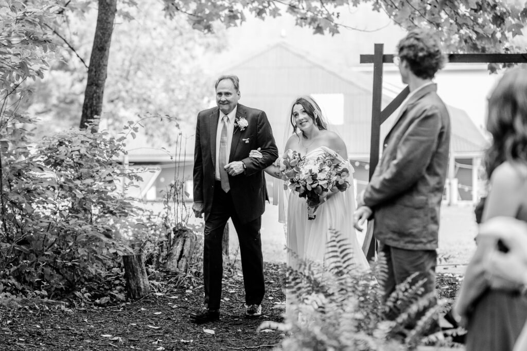 A bride looking up as she enters her ceremony in front of her Northern VA wedding photographer