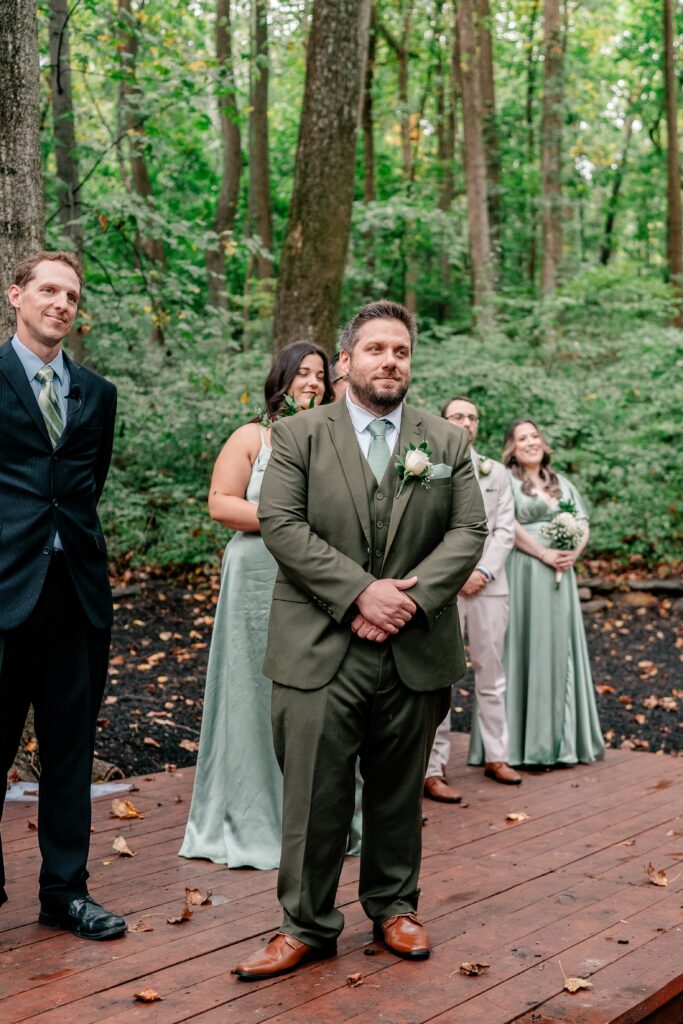 A Stone Manor Boutique Inn wedding as the groom sees his bride walking down the aisle