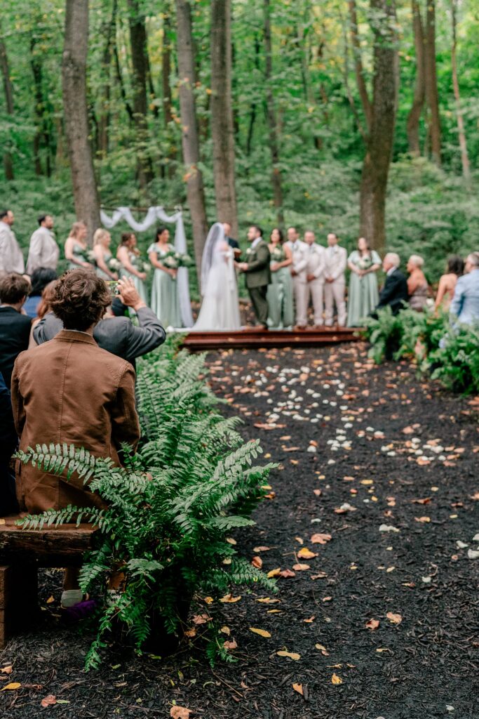 A Stone Manor Boutique Inn wedding ceremony with lush ferns in the aisle