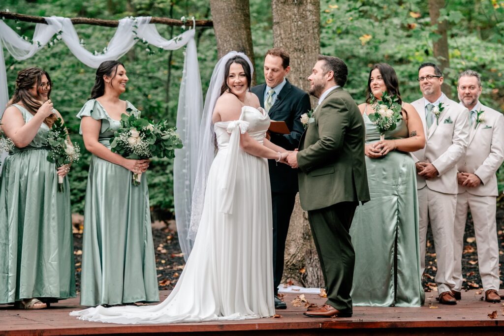 A bride smiling over her shoulder during the ceremony with her Northern VA wedding photographer