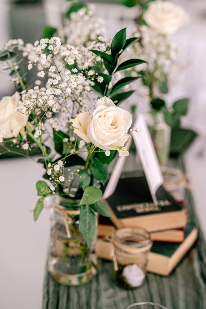 A close up detail of roses and baby's breath for table centerpieces at a wedding