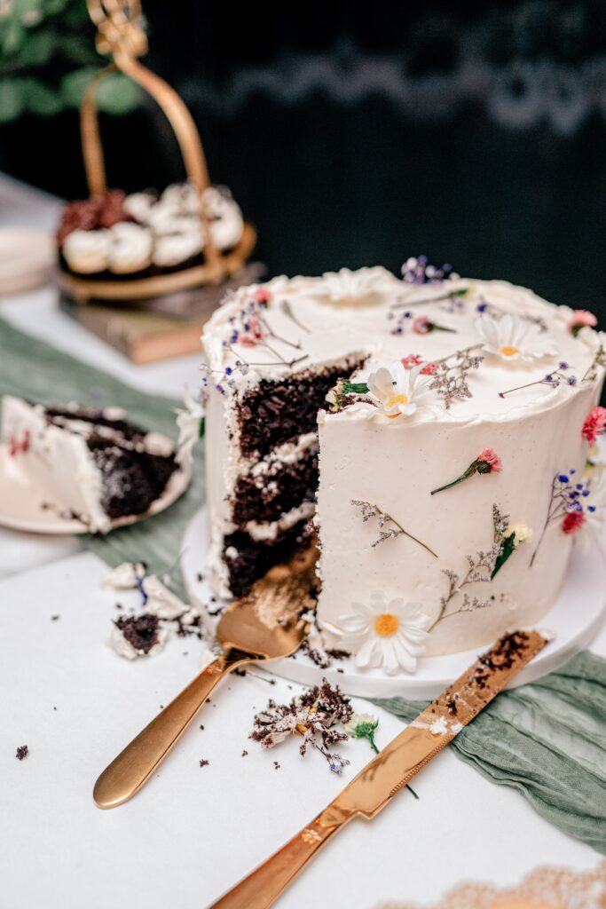 The cut cake with crumbs around it at a Stone Manor Boutique Inn wedding reception