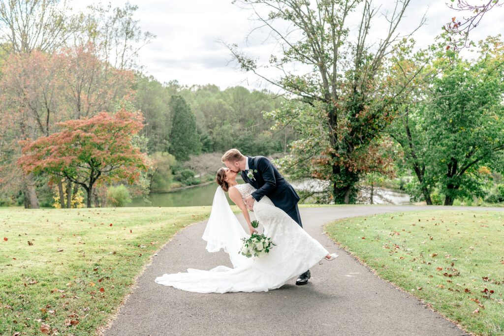 A dramatic dip kiss on the Great Lawn by a Northern VA wedding photographer