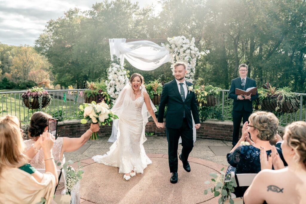 A bride cheering as she exits her wedding ceremony