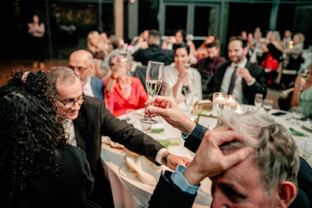 A guest raises a glass for a toast at a Meadowlark Botanical Gardens wedding