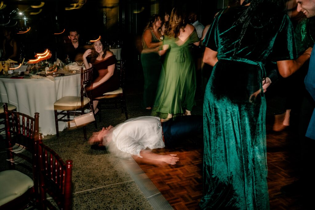 An Atrium at Meadowlark wedding reception dance floor with a guest on the ground and blurry