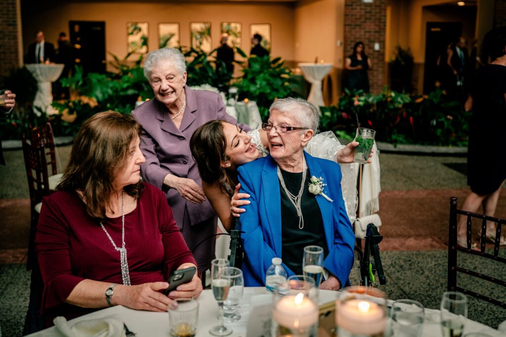 A bride greets her older relatives during her reception
