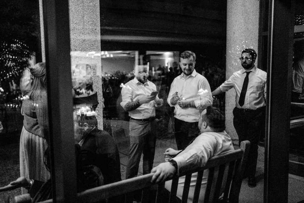 A group of guys hanging out outside the reception documented by a Northern VA wedding photographer