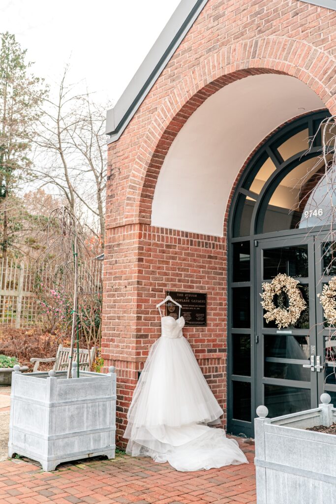 A wedding dress hanging from the entrance to the venue