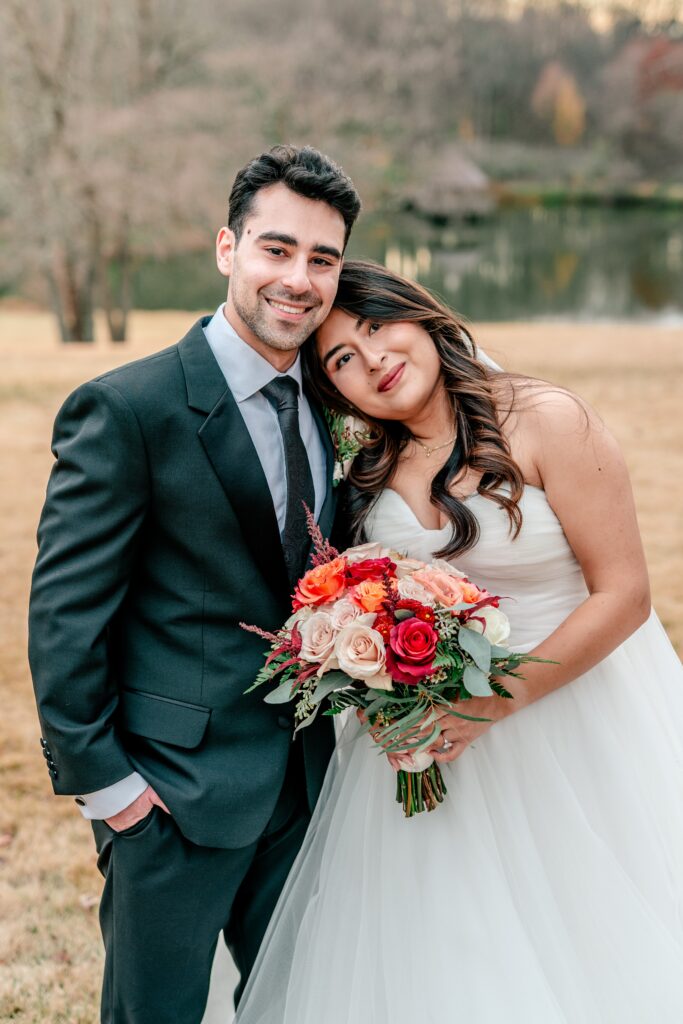 A sweet portrait of a bride resting her head on her groom's shoulder posed by their Northern VA wedding photographer