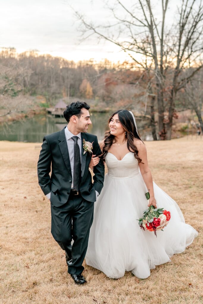 A bride and groom walking together at golden hour