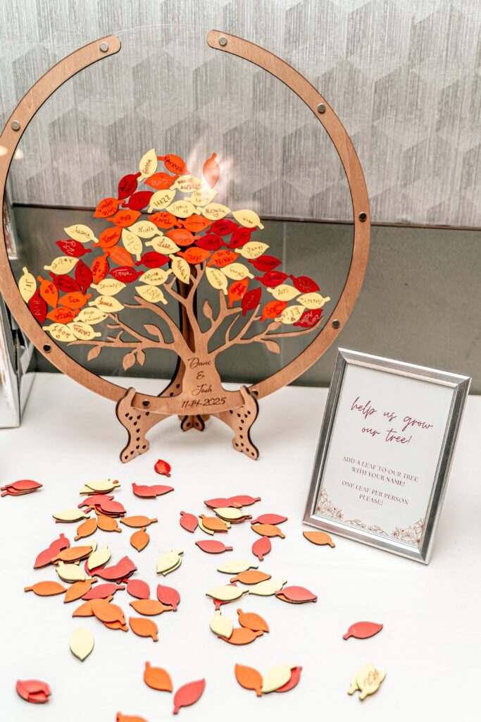 A guest book alternative featuring fall leaves signed by guests in a wooden display, photographed by a Northern VA wedding photographer