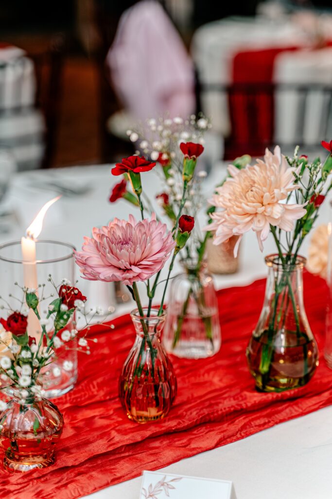Pink and peach flowers set for a November wedding reception