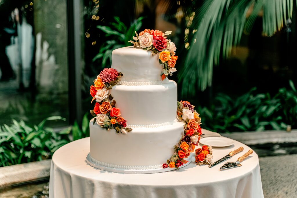 A cake decorated with sugar flowers for a Meadowlark Botanical Gardens fall wedding