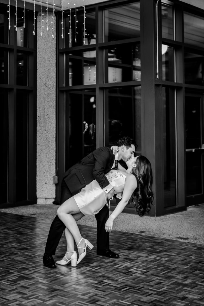 A bride and groom share a dip kiss to end their Meadowlark Botanical Gardens fall wedding
