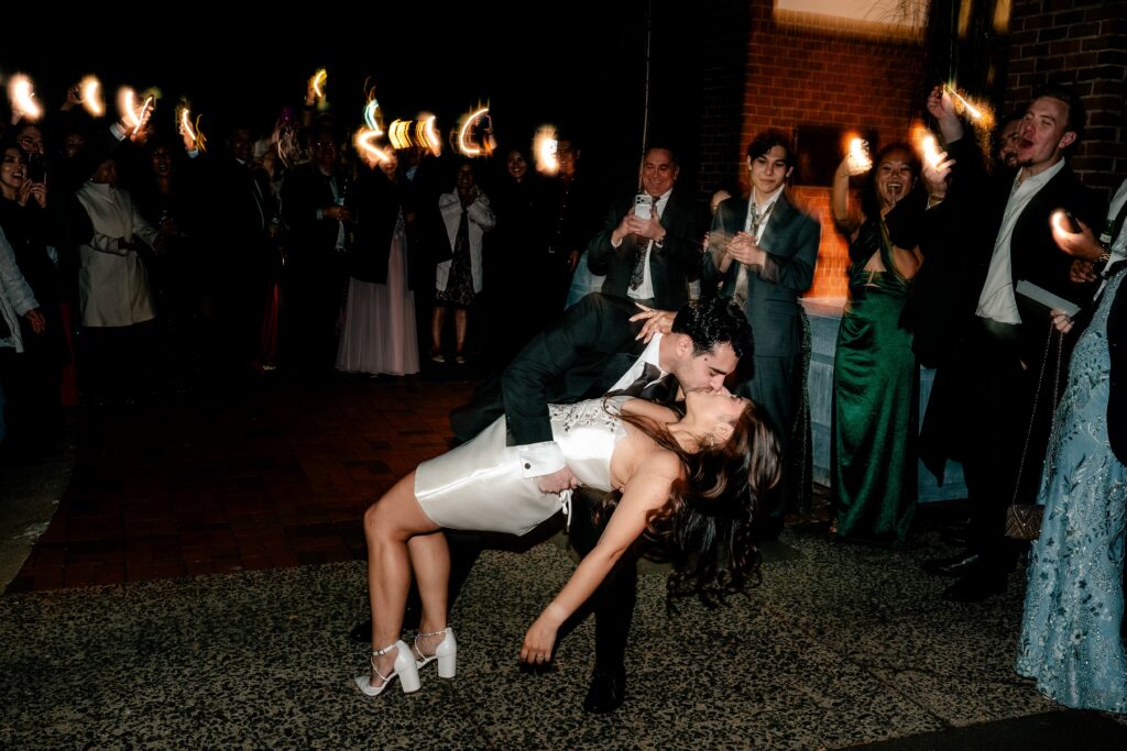 A dramatic dip kiss during a flashlight sendoff from a Meadowlark Botanical Gardens fall wedding