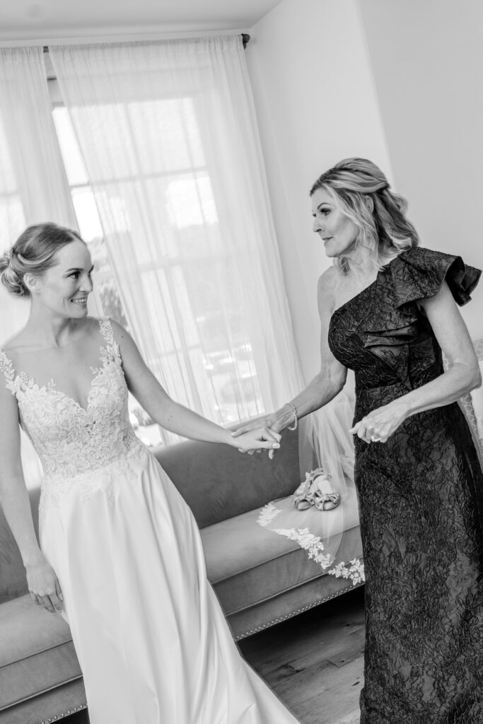 A bride and her mom getting ready for their Catholic wedding photographer