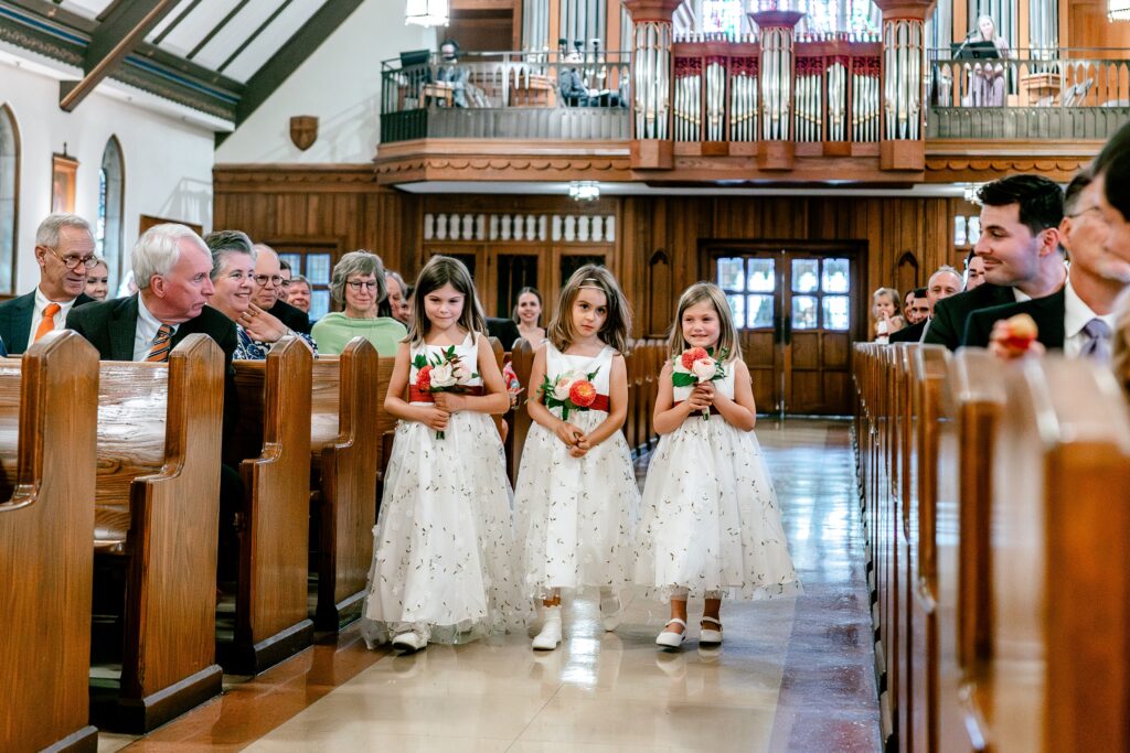 Flower girls processing down the aisle for a The Estate at Independence wedding