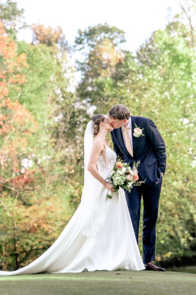 A bride and groom share a kiss for their The Estate at Independence wedding portraits