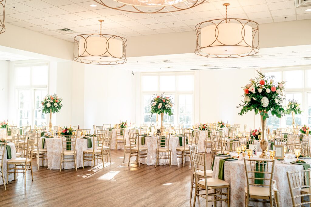 Tall centerpieces with warm flower arrangements for a The Estate at Independence wedding reception