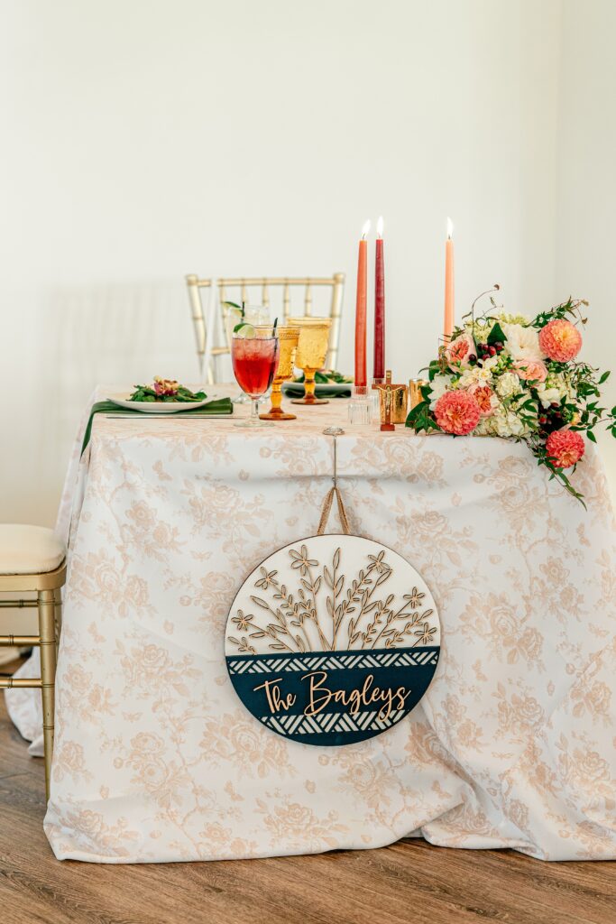 A sweetheart table with taper candles and the bride's bouquet captured by a Richmond wedding photographer